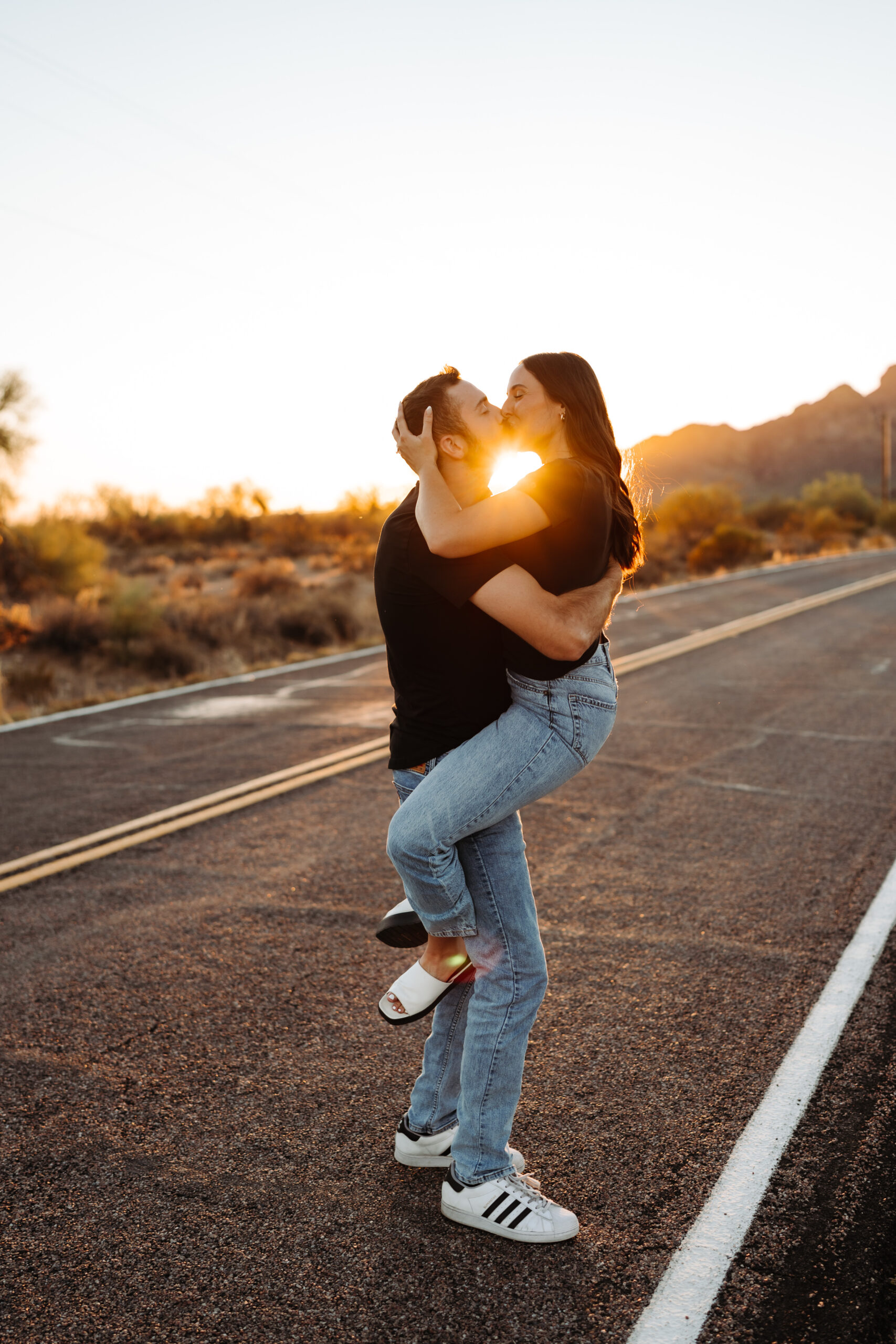 Couple kissing on the road at sunset at Phon D Sutton.