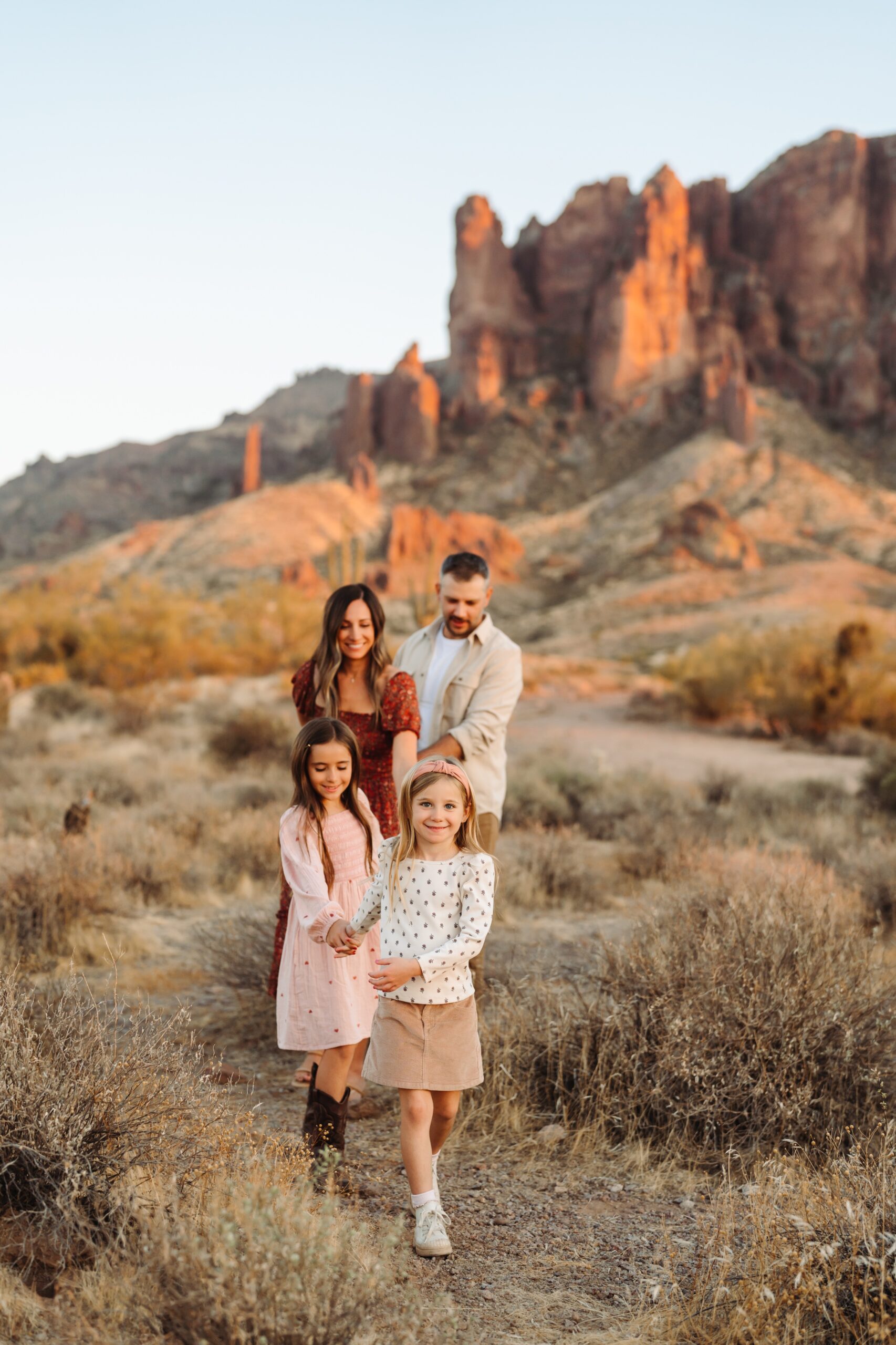 A family walking in front of Superstition Mountains at Lost Dutchman State Park