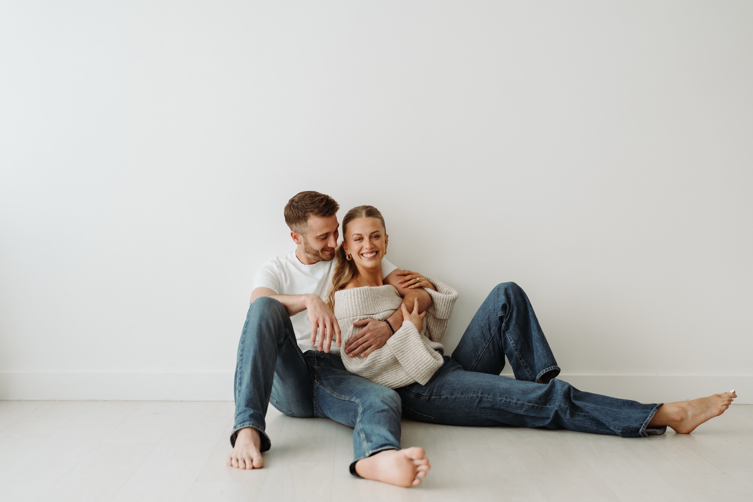 A couple sitting on studio floor