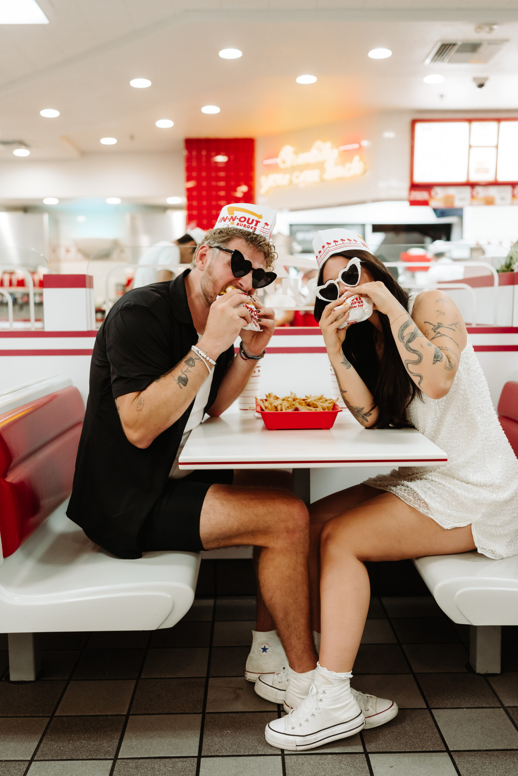 Couple eating In-N-Out burgers for engagement photos